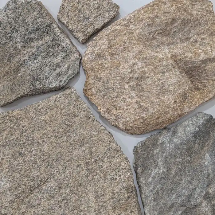 Tora Mix loose random granite wall cladding with earthy tones and textured grey natural stone for outdoor feature walls and facades.